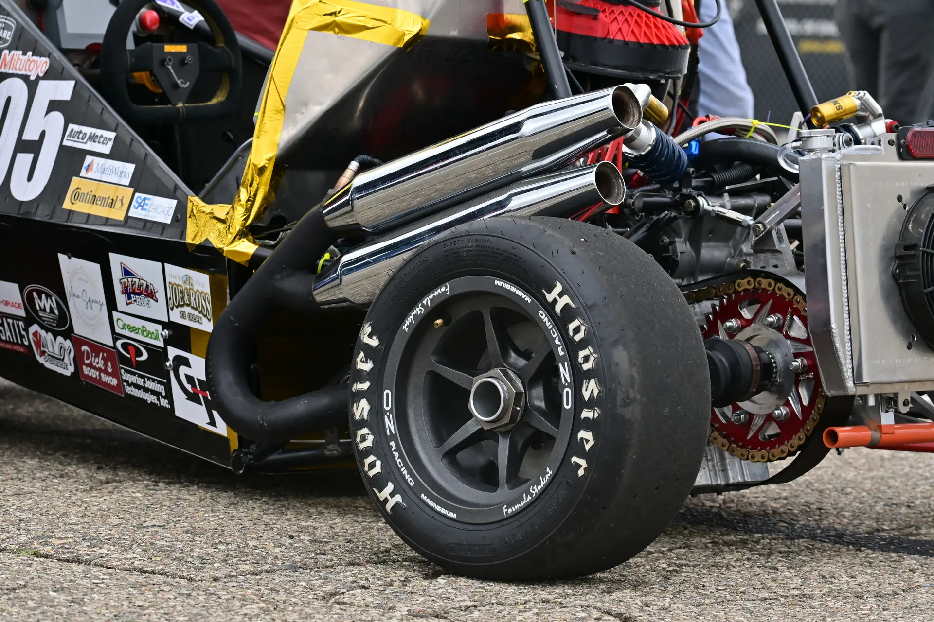 Team members building and assembling the race car in the workshop.